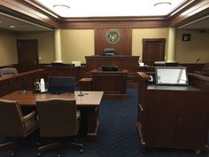 This contain an image of a courtroom with desks and chairs