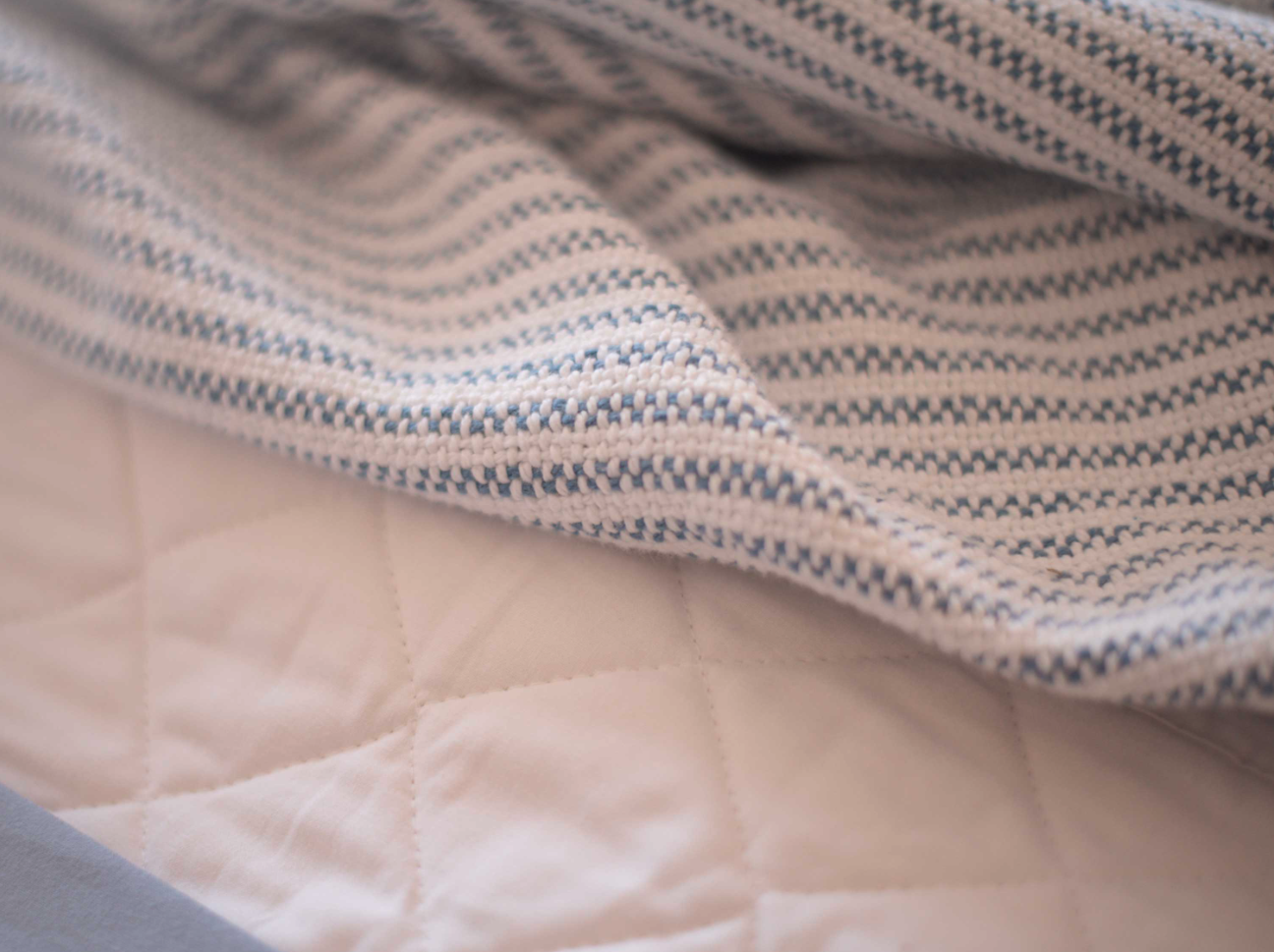 Ticking Stripe Blanket is perfect for layering or curling up on the couch, this blanket brings warmth and texture with a soft, vintage feel.