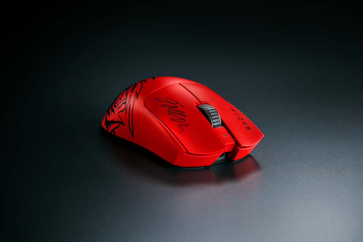 A red computer mouse with a black design

Description automatically generated