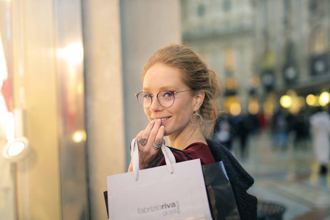 Free Close-Up Photography of a Woman Holding Paper Bags Stock Photo