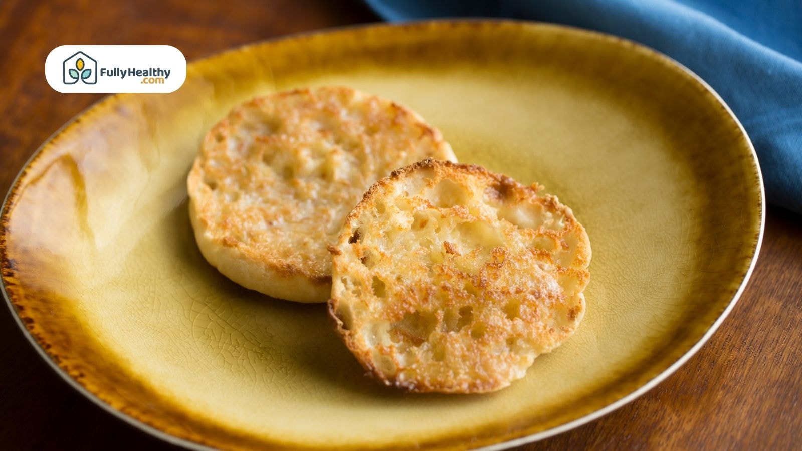 Toasted plain English muffins on a yellow plate with crisp edges
