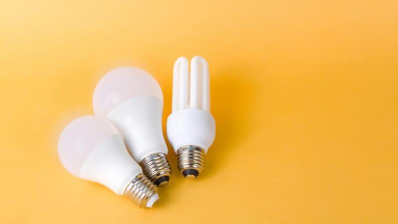 Different-sized LED light bulbs in front of Yellow Background