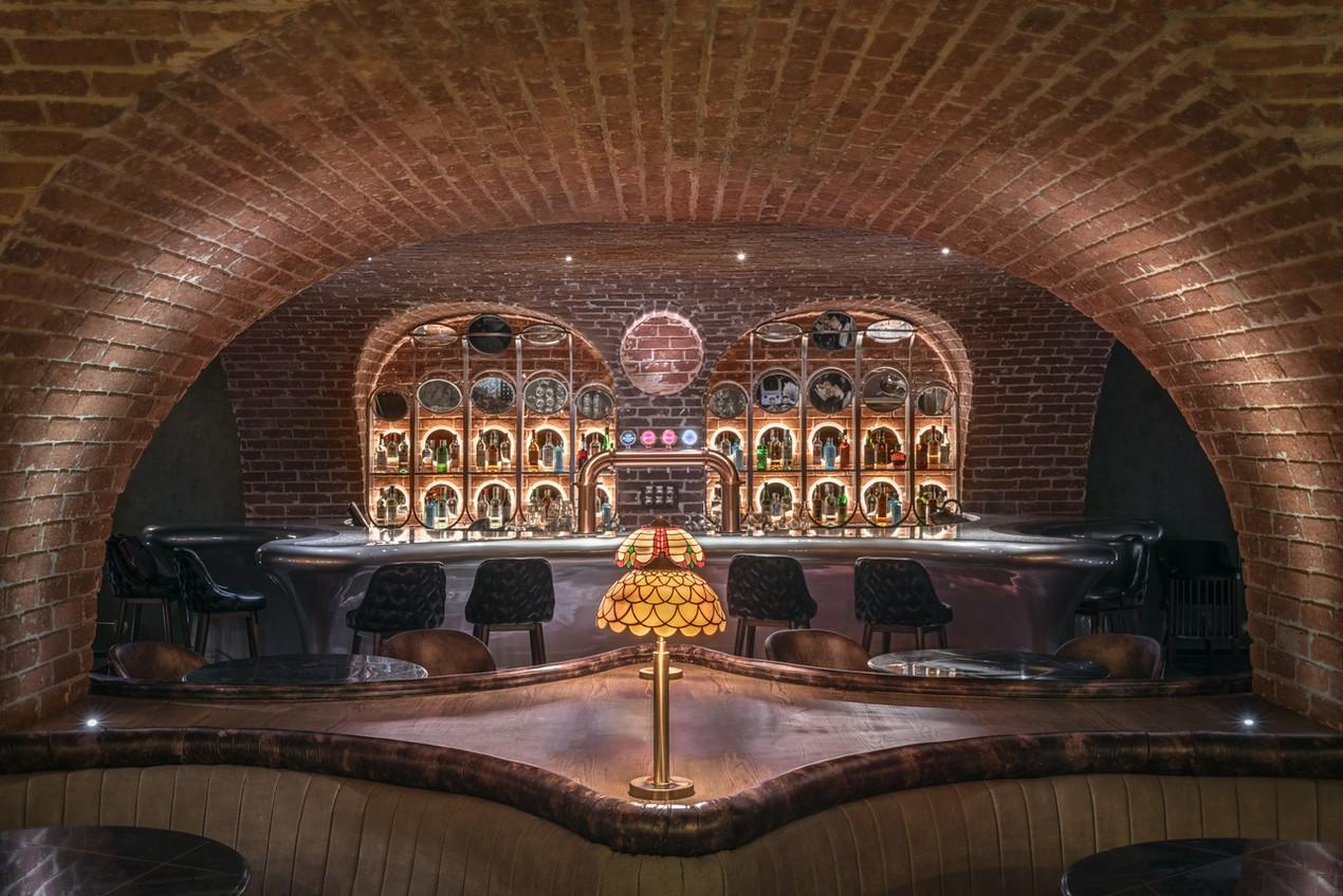 The seating area showing bar stools and plush seats, enhancing the inviting atmosphere that would captivate any fan of architectural photography.