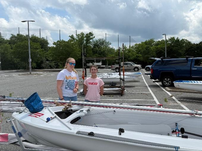 A couple of people standing next to a rowboat

AI-generated content may be incorrect.