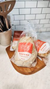 Wildgrain box featuring a variety of artisan breads, pastries, and pasta products