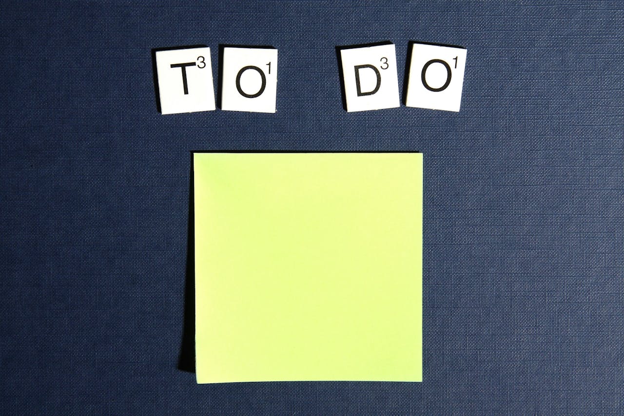 Sticky note with Scrabble tiles spelling 'To Do,'