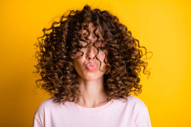 Healthy curly hair after split end treatment and consistent use of a split end cutter and oils.