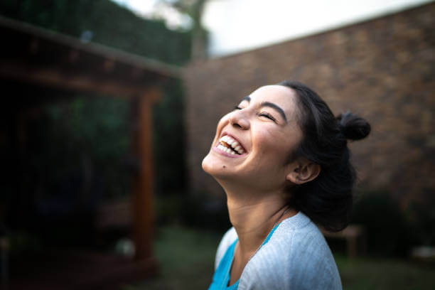 A vibrant, carefree woman enjoying life with radiant health and energy, showcasing the positive effects of hormone balance supplements.