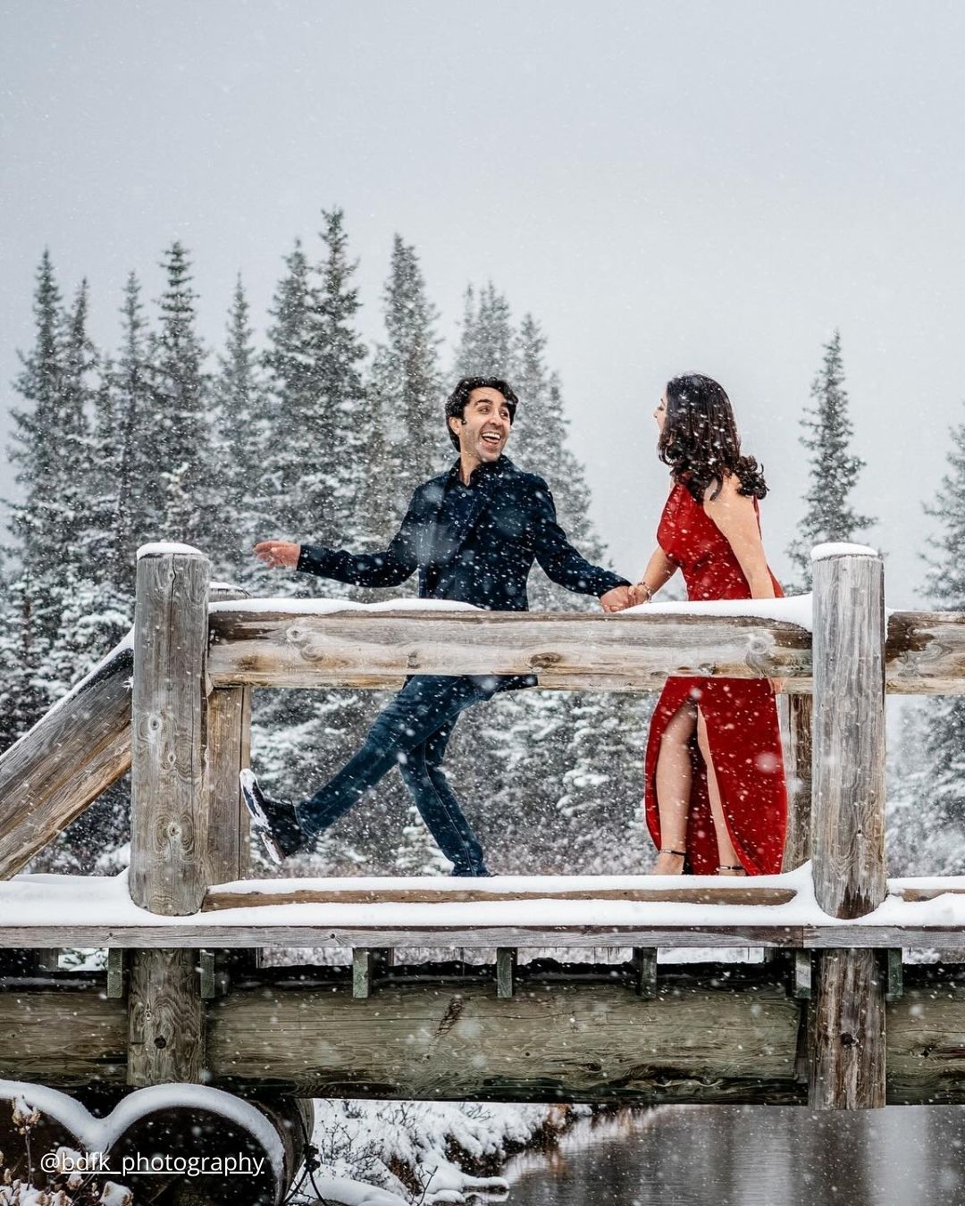 winter engagement photos couple is having fun on the snow