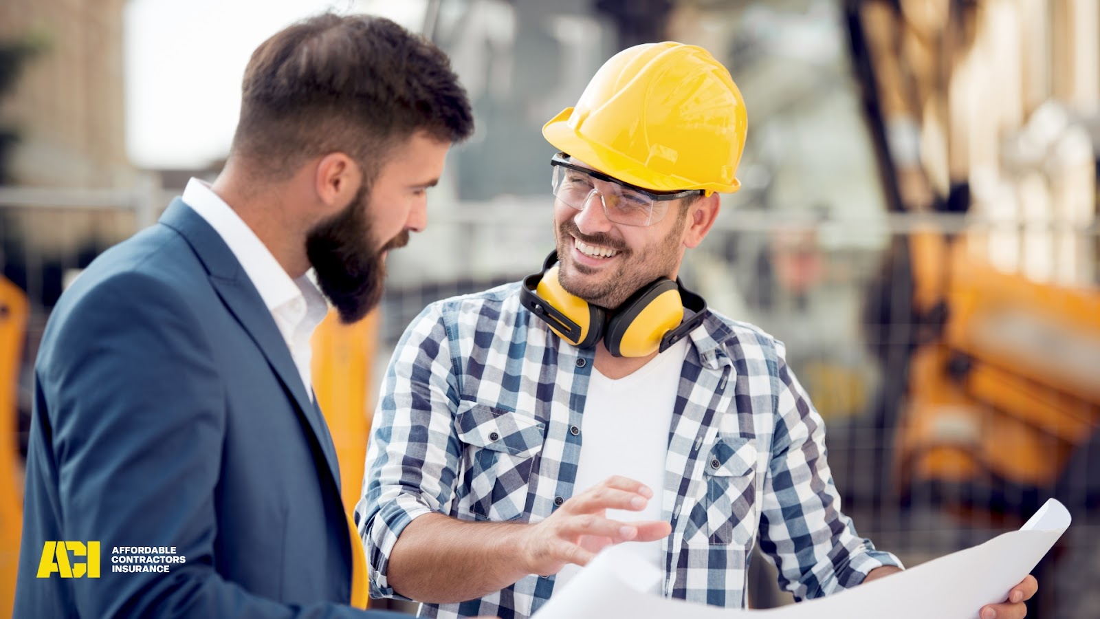 Construction contractor reviewing plans at job site