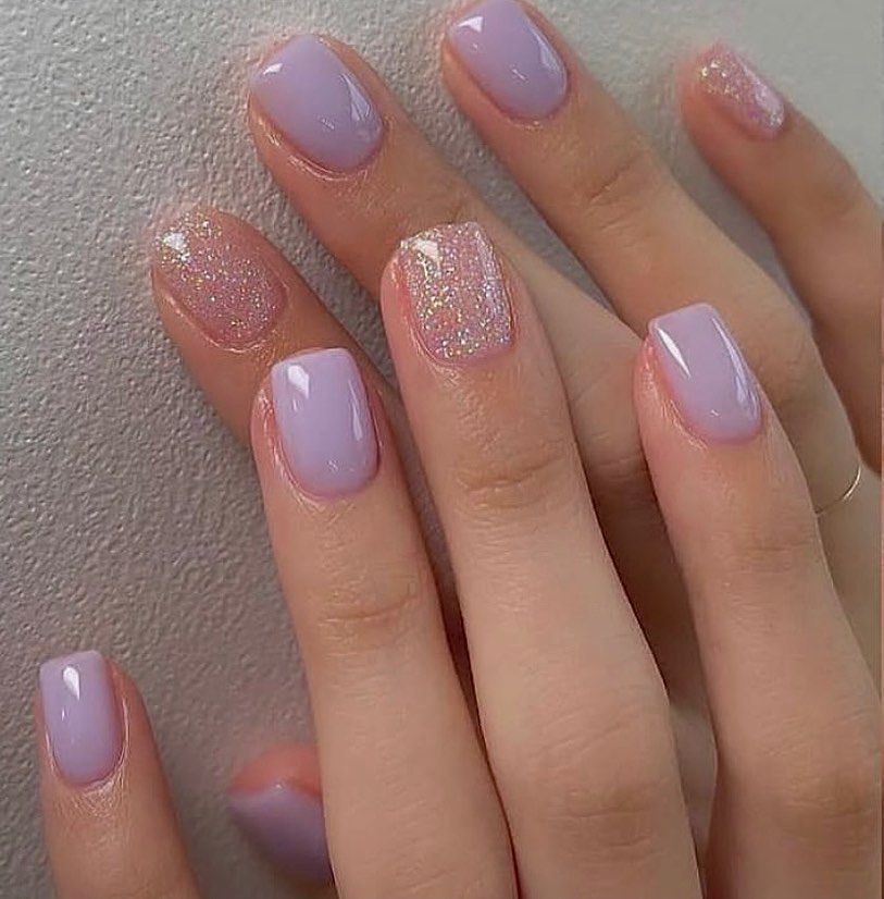 Close-up of hands having lavender nails with Short and Sweet designs