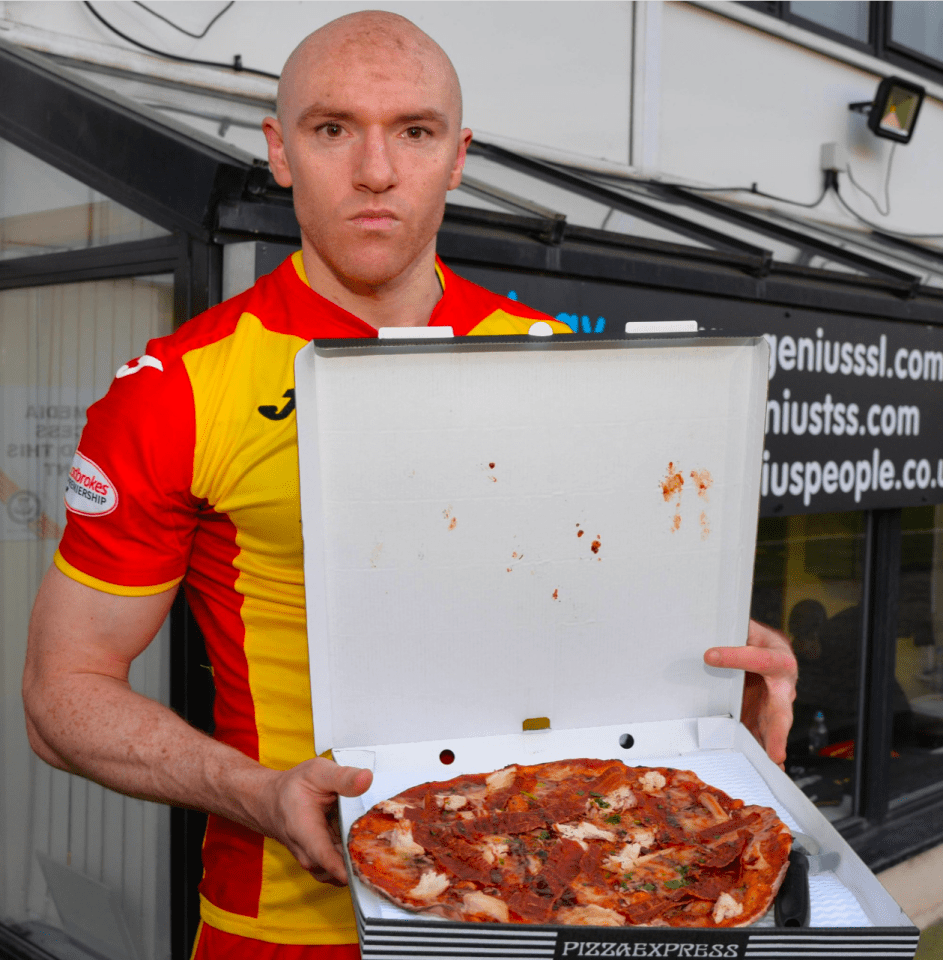 Connor Sammon shows off a pizza from Pizza Express