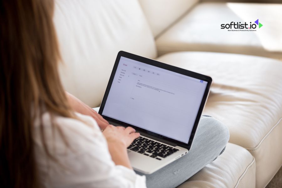 Person typing on laptop with Softlist.io logo in upper right corner