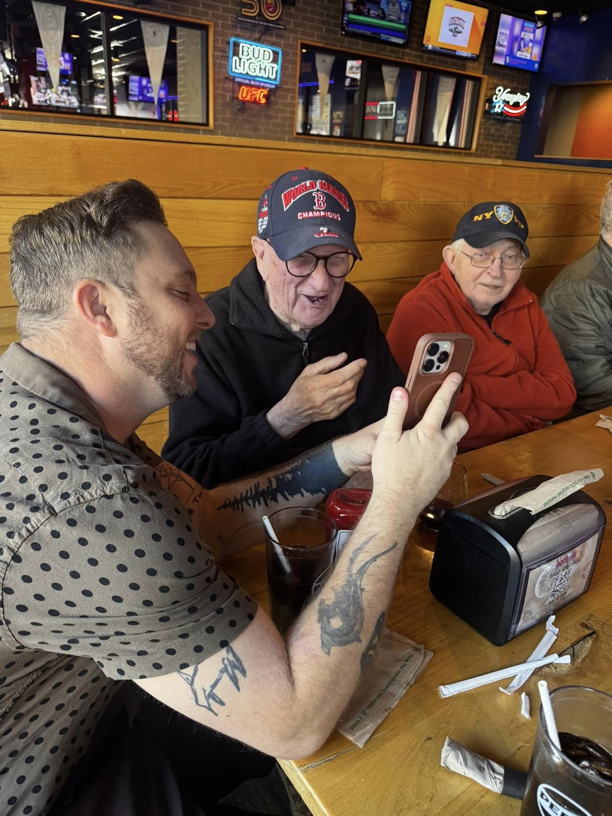 An assisted living caregiver showing a senior a picture on a cell phone