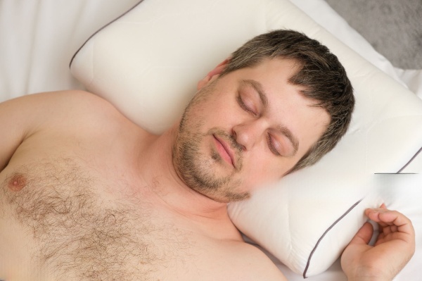 A close-up view of a person's head resting comfortably on an orthopetic  pillow,