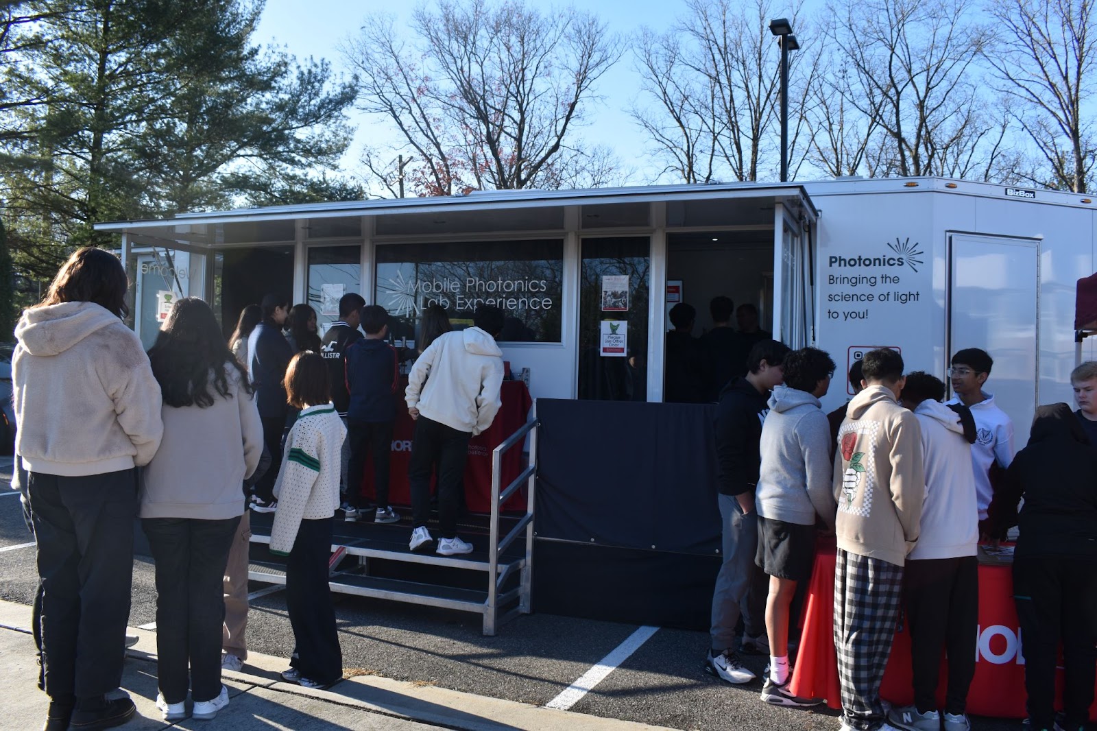 Students from Thomas Jefferson High School for Science and Technology waiting outside a mobile science lab. 