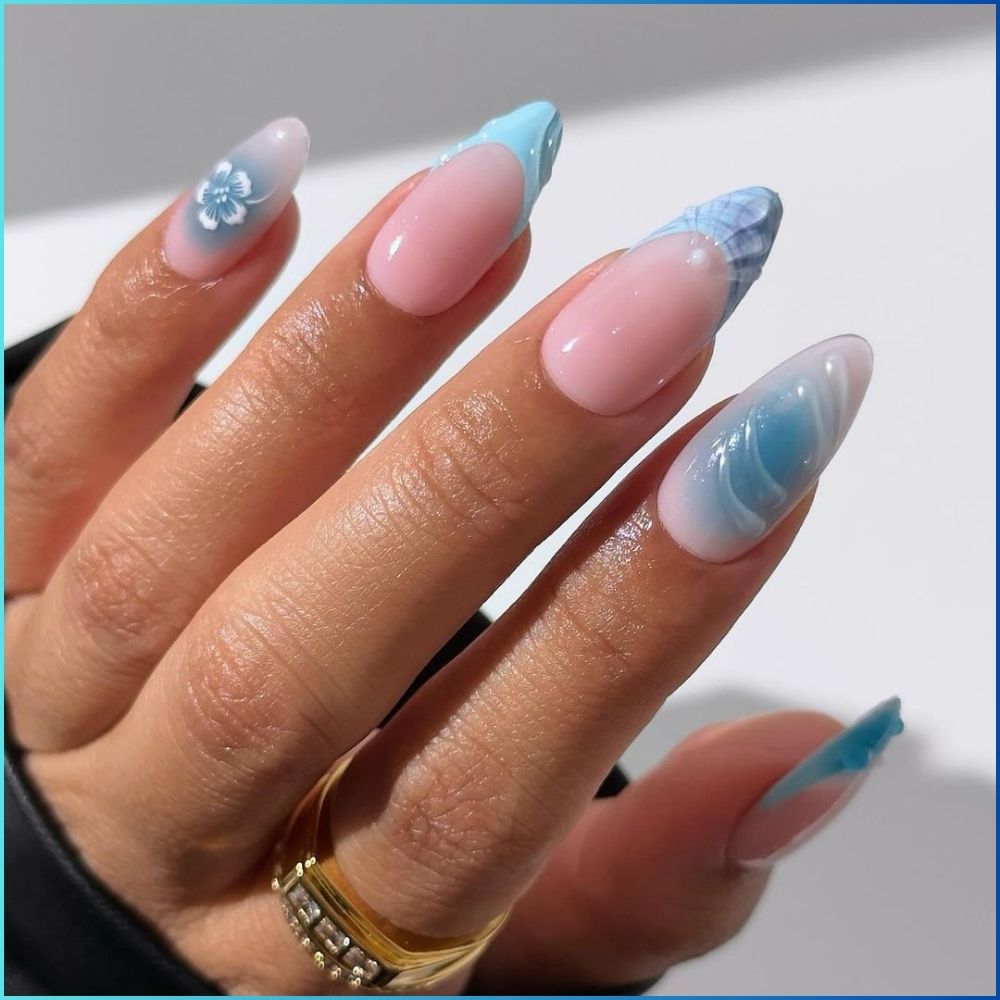 Close up of hands with flowered designed blue nails having Blue Shell Nail Art