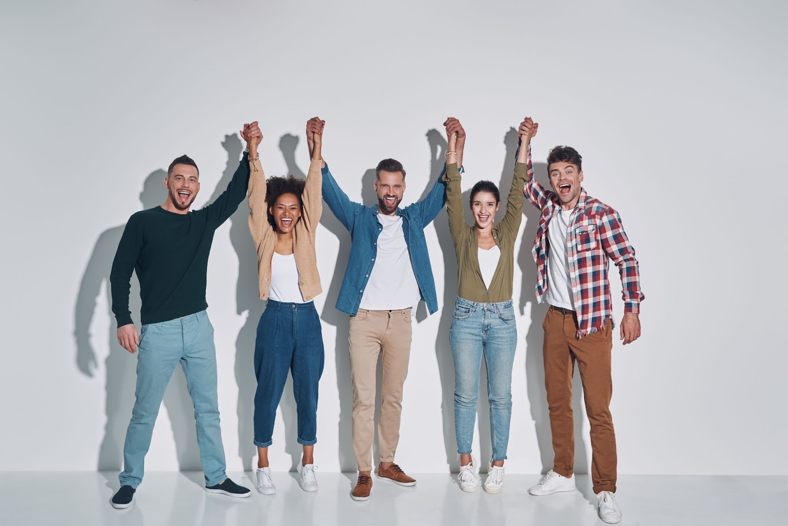 Group of happy people holding hands