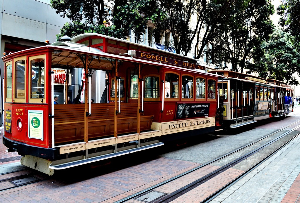 Cable car in red color and with yellow border and has destination board