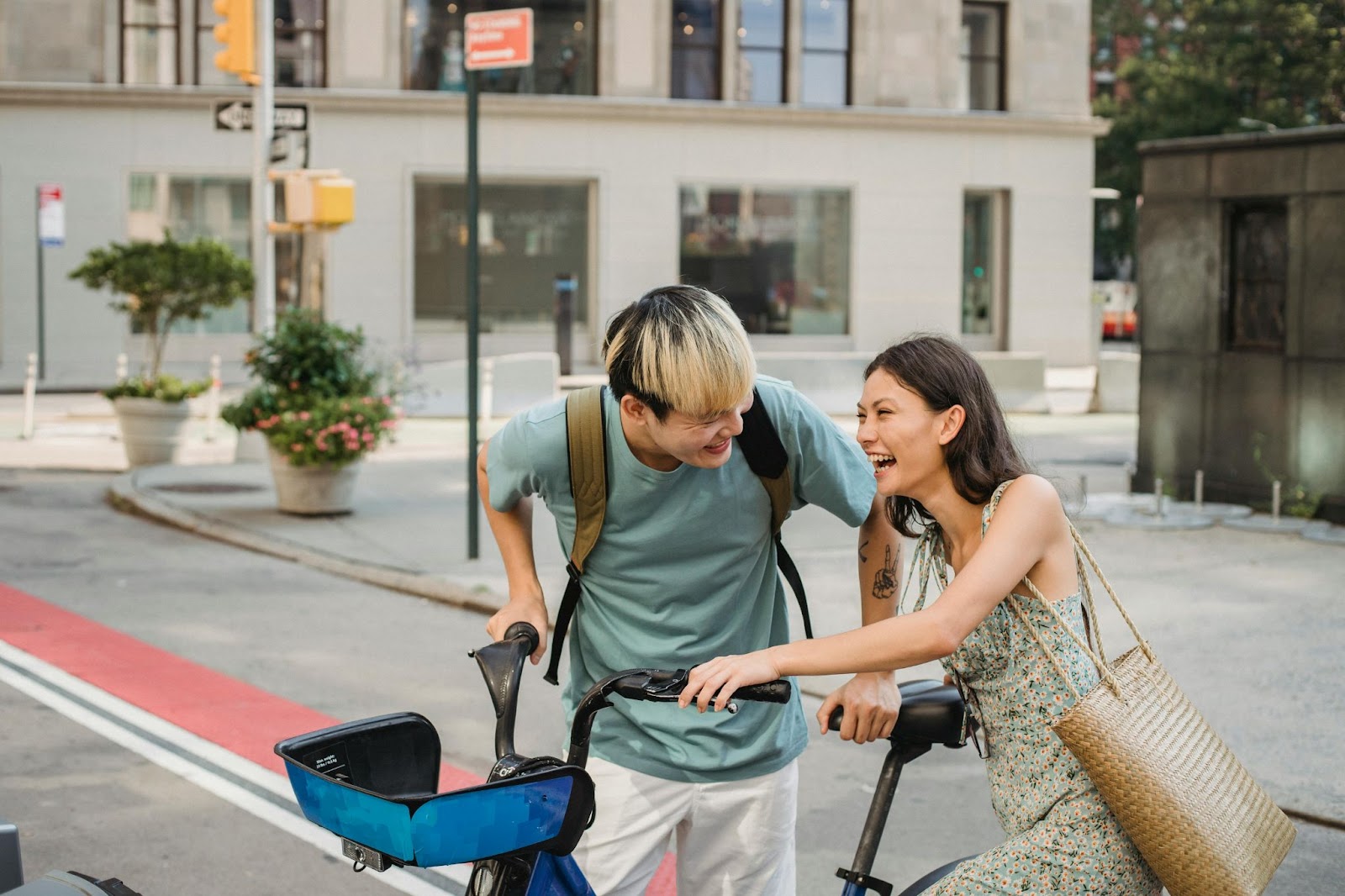 A man and a woman using a rented electric bike in Paris during the summer.