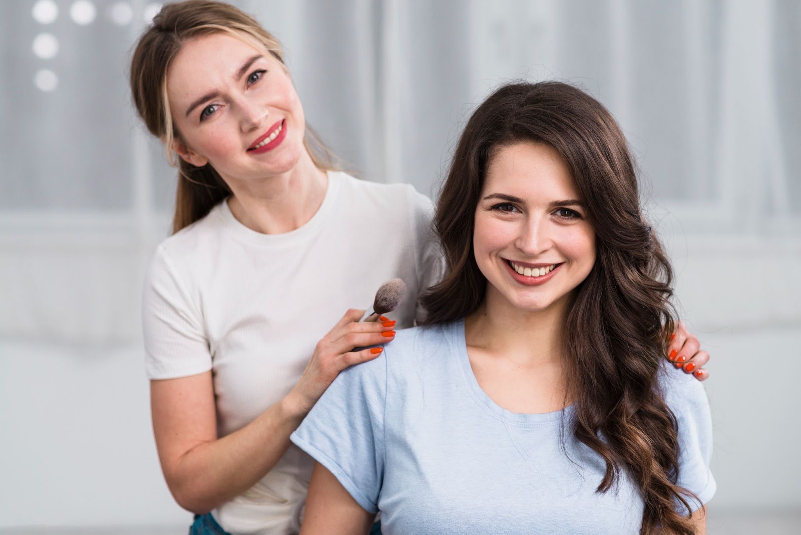 Happy hairstylist and client looking at the camera