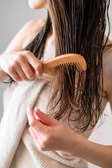 A woman combing her wet hair