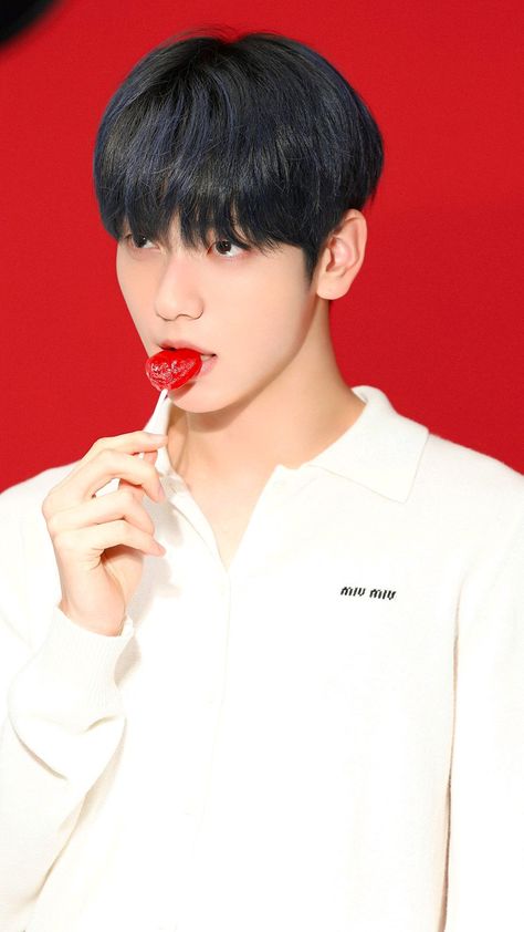 This contains an image of Soobin while wearing a white shirt and red lipstick on the lips