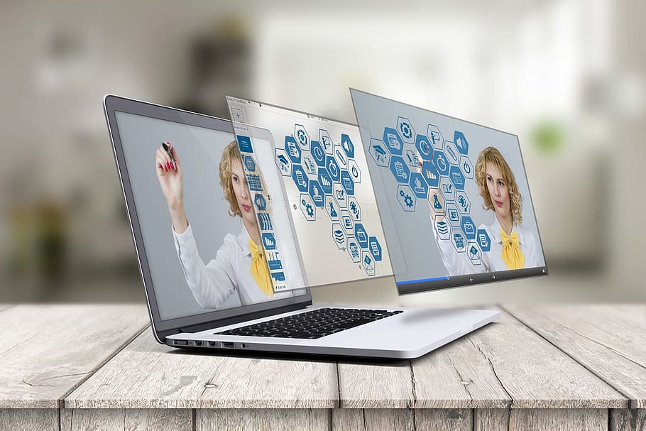 Holographic display of a teacher on a MacBook