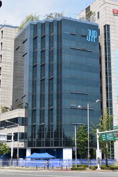 This  contain an office building with the word jpp on it's side in front of other buildings