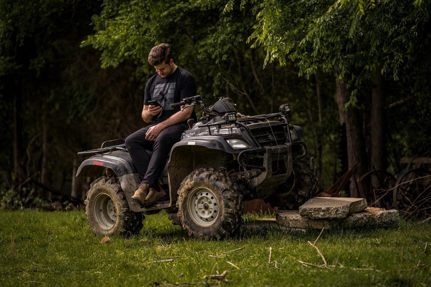 A person sitting on a four wheeler

Description automatically generated