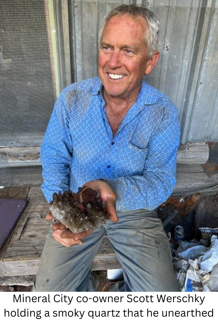 Mineral City co-owner Scott Werschky holding a smoky quartz that he unearthed