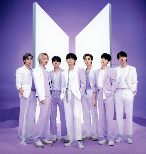 This contains an image of BTS group members standing next to each other in front of a purple background