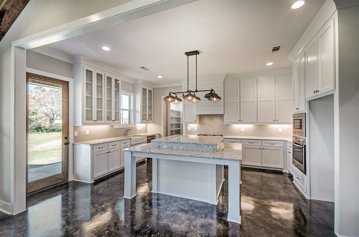 The kitchen has direct access to the rear porch via a glass door.