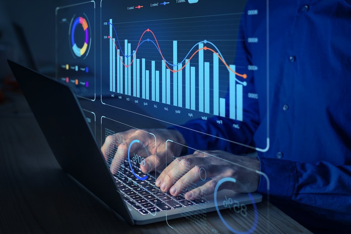 HR data analytics: entrepreneur using a laptop to look at graphs and data