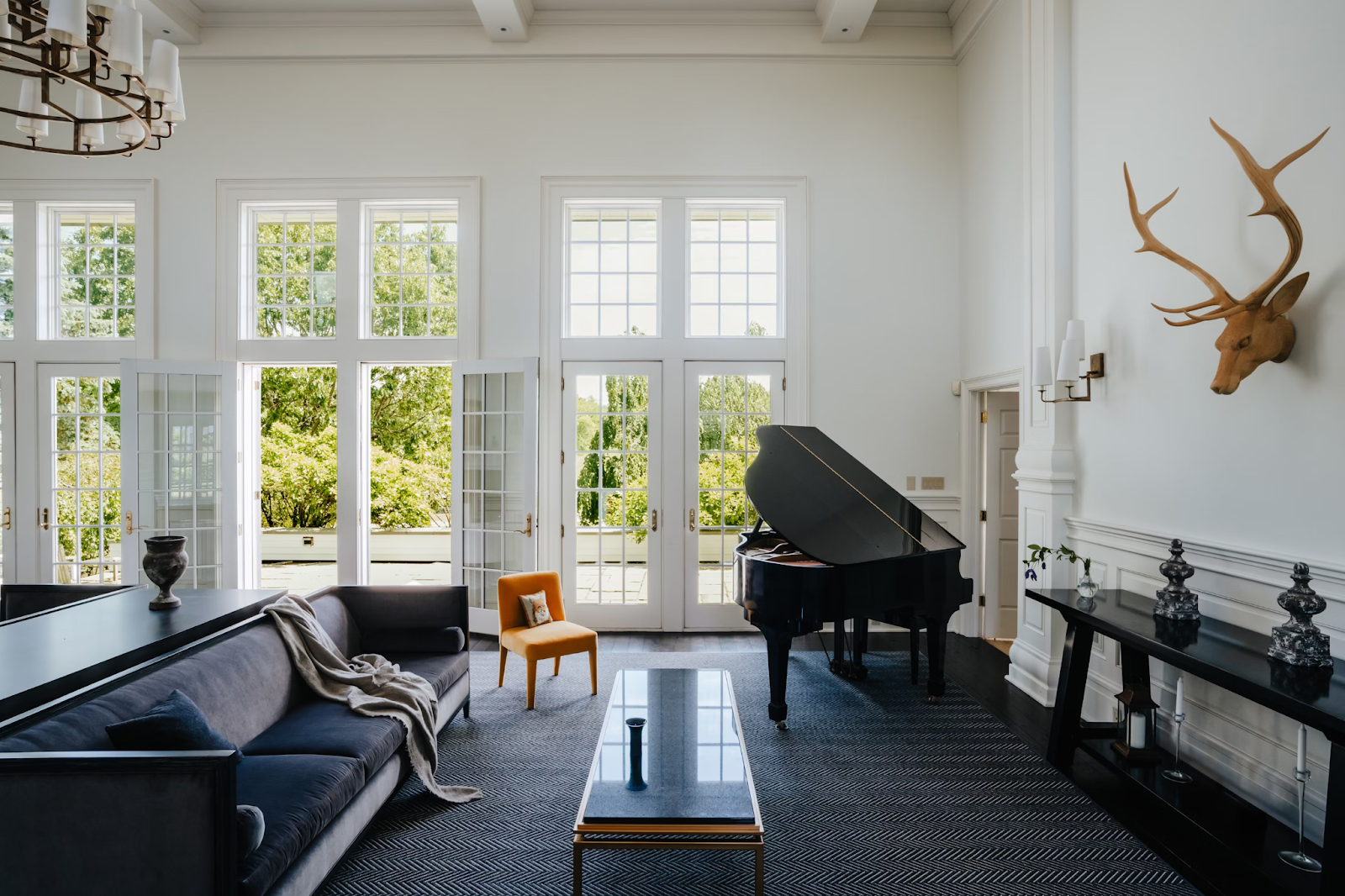 This image depicts white French doors opening to a terrace from a living room.