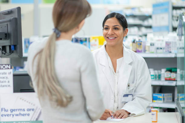 Pharmacist at Magnolia Pharmacy discussing magnesium supplements with a customer, offering expert advice for managing brain fog.