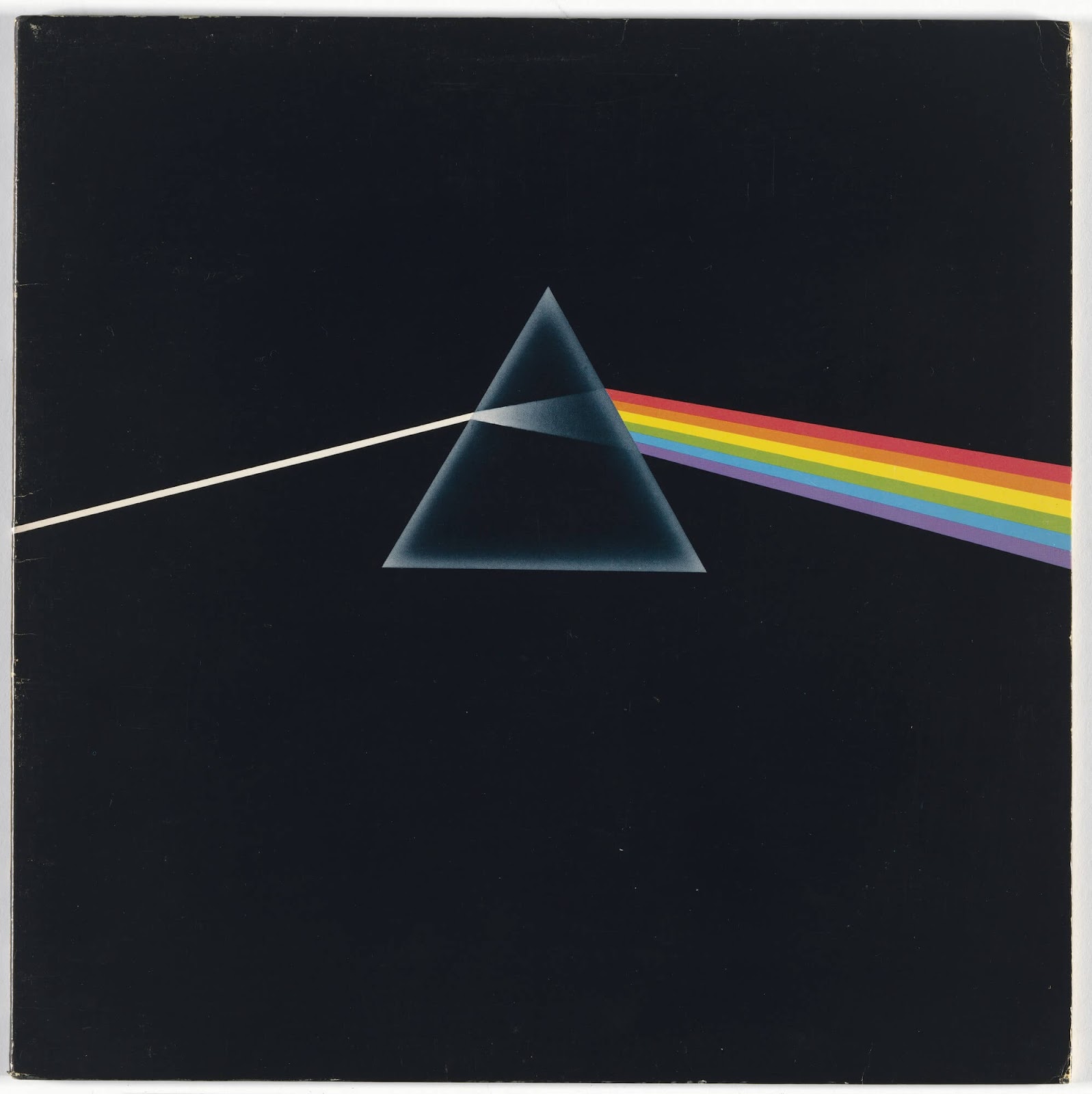 Pink Floyd's 'Dark Side of the Moon' album cover featuring a prism dispersing light into a rainbow against a black background.