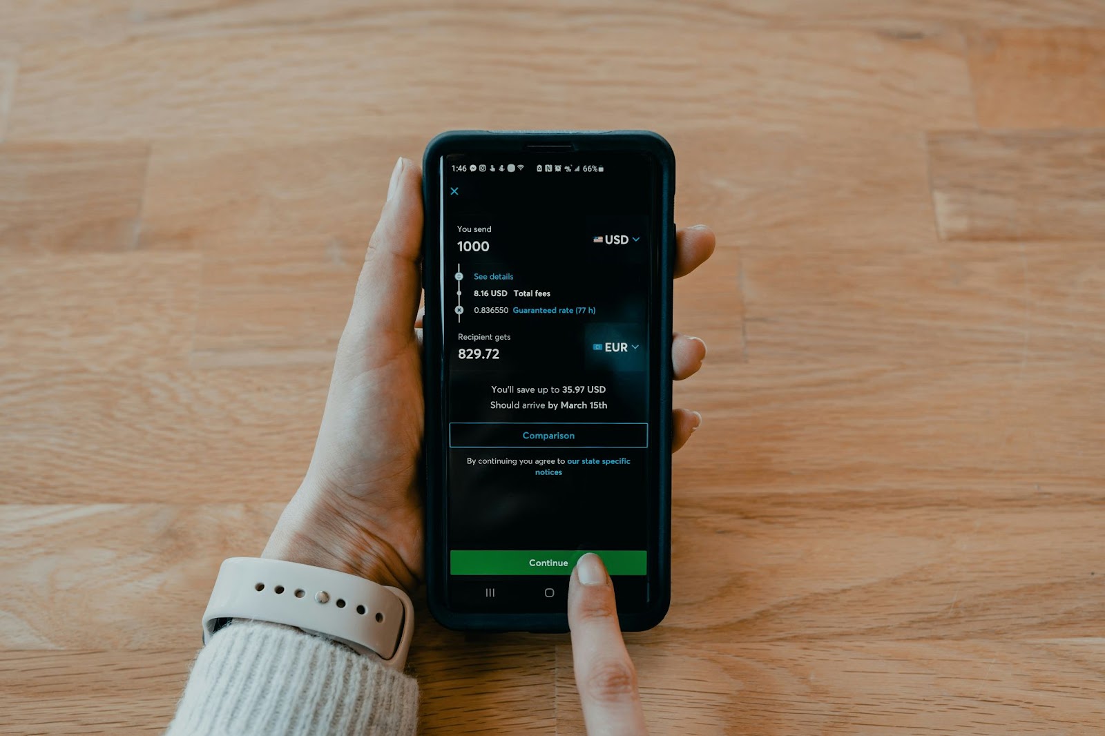 Person holding a smartphone displaying a conversion transaction checking PayPal chargeback scam