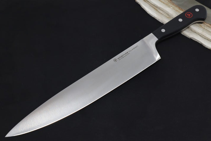 An image showing a Wusthof Classic chef's knife with its traditional triple-riveted handle and high-carbon stainless steel blade.