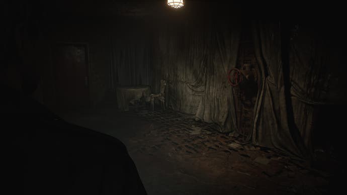 Cuplikan layar dari Silent Hill 2 Remake: James menatap dinding di rumah sakit Dunia Lain. Segala sesuatu mulai dari dinding hingga perabotan ditutupi kain lap debu yang kotor dan berjamur. Sebuah katup berkarat menyembul keluar dari dinding.