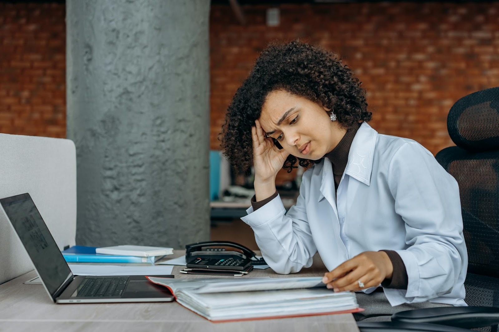 https://www.pexels.com/photo/an-exhausted-woman-reading-documents-8297240/