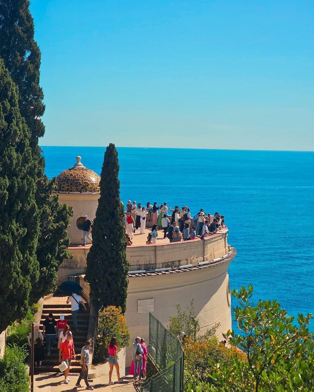 A group of people standing on a building

Description automatically generated