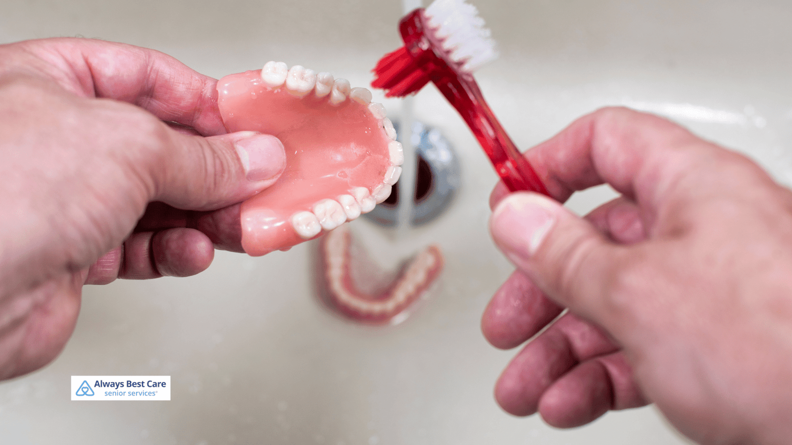 This is an image depicting a person brushing their denture