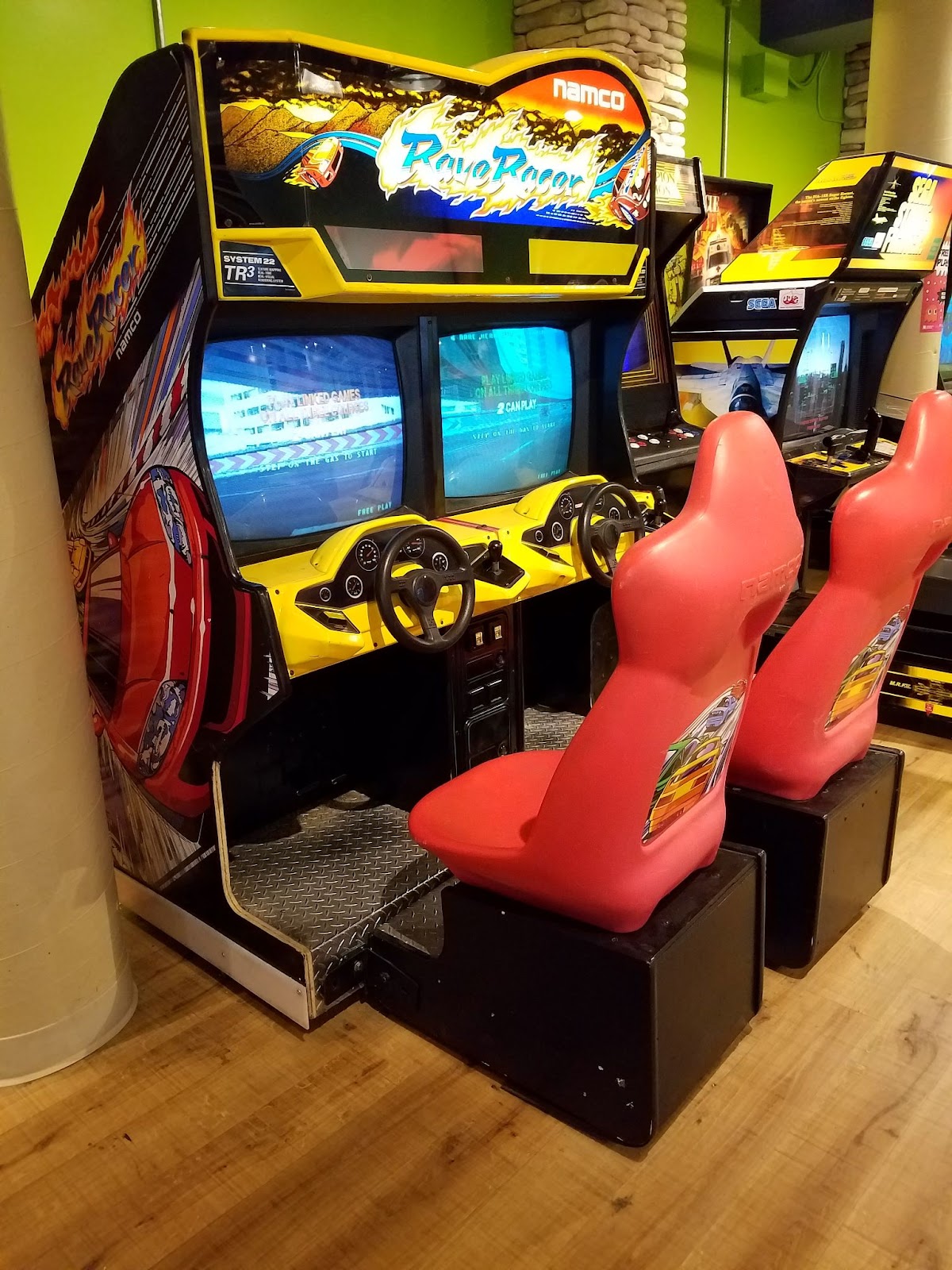 American Rave Racer cabinet with yellow dashboard and 2 seats.