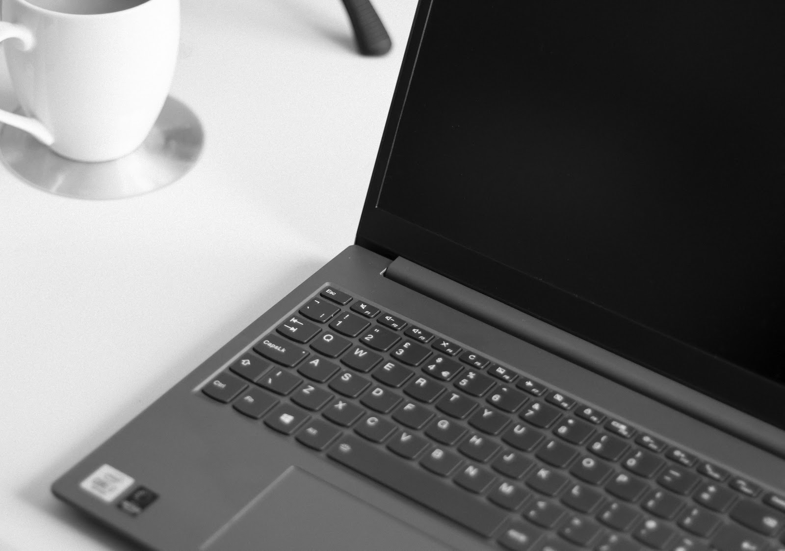 black laptop computer on white table