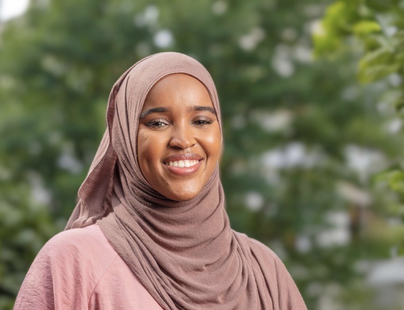 Rep. Munira Abdullahi smiles in a headscarf