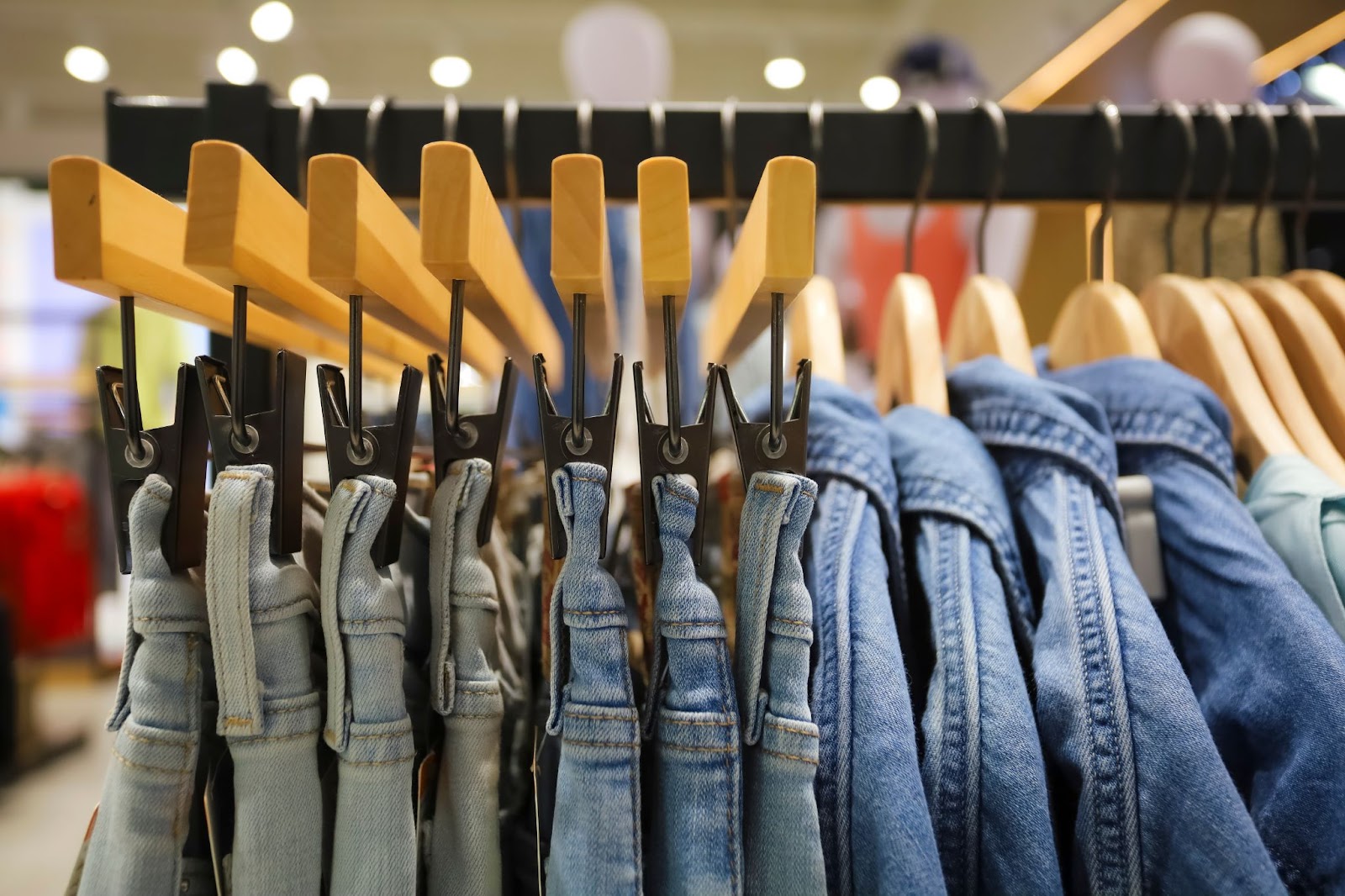 A rack of consigned denim pieces for sale at a consignment boutique.