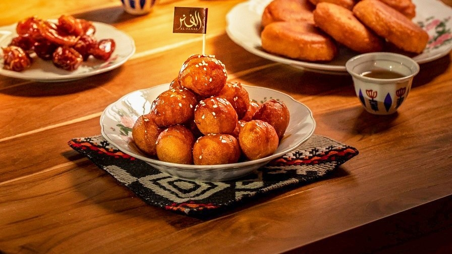 Golden Brown Luqaimat with Honey Drizzled on Them - best local street food in Jeddah - (Credits MICHELIN Guide)
