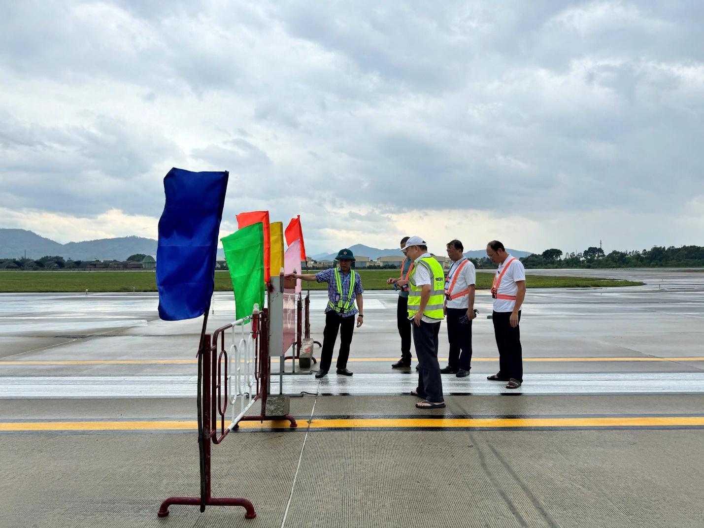 A group of people standing on a runwayDescription automatically generated