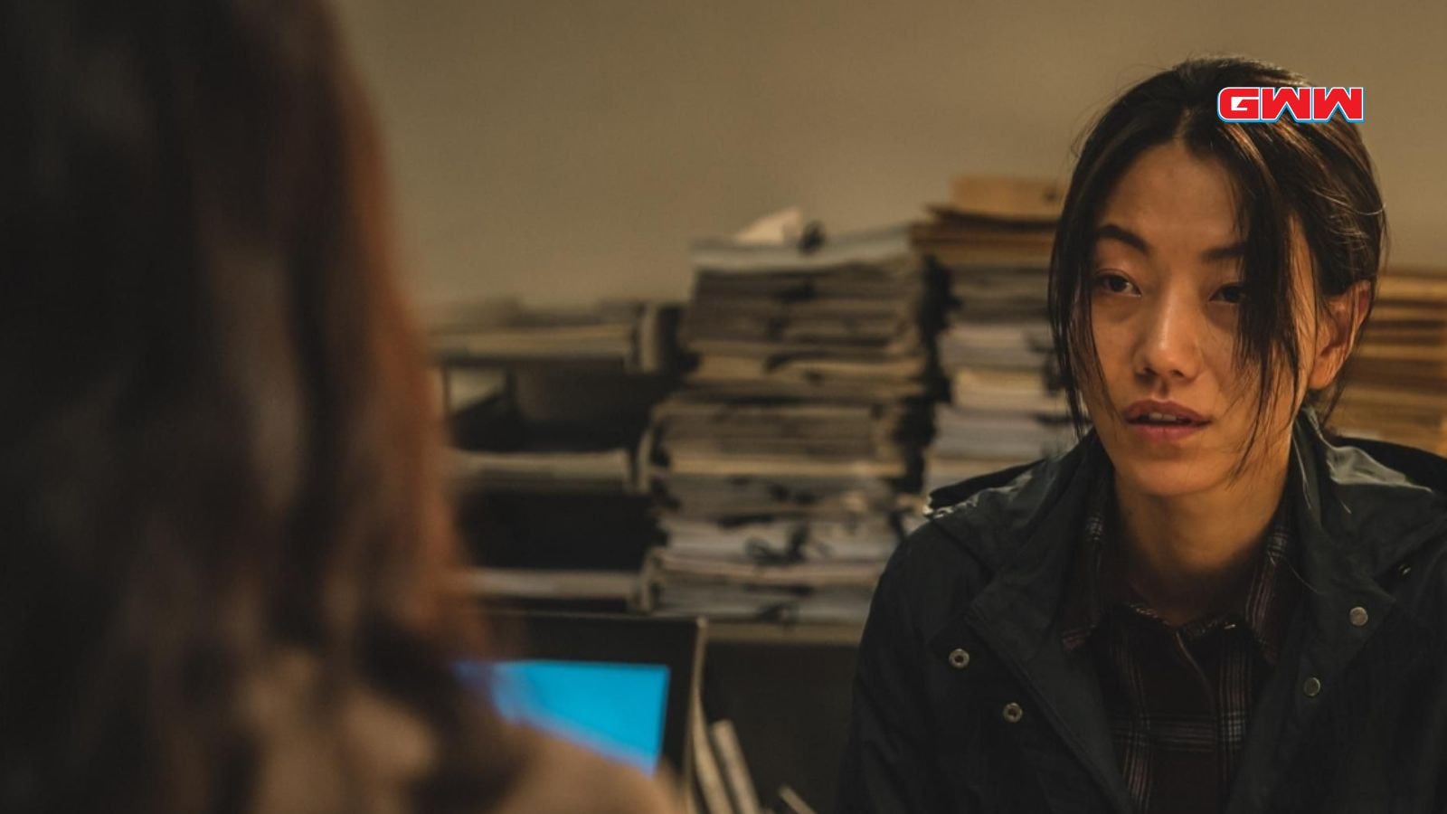 Kim Shin-rock at a desk, engaging in a serious conversation.